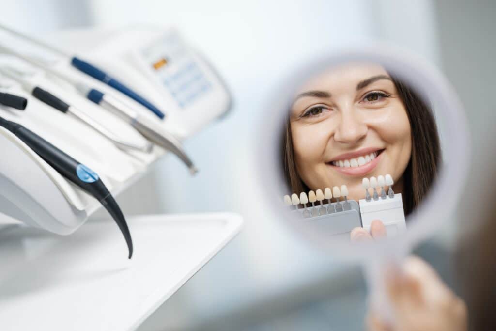 Young Girl Holding Dental Veneers