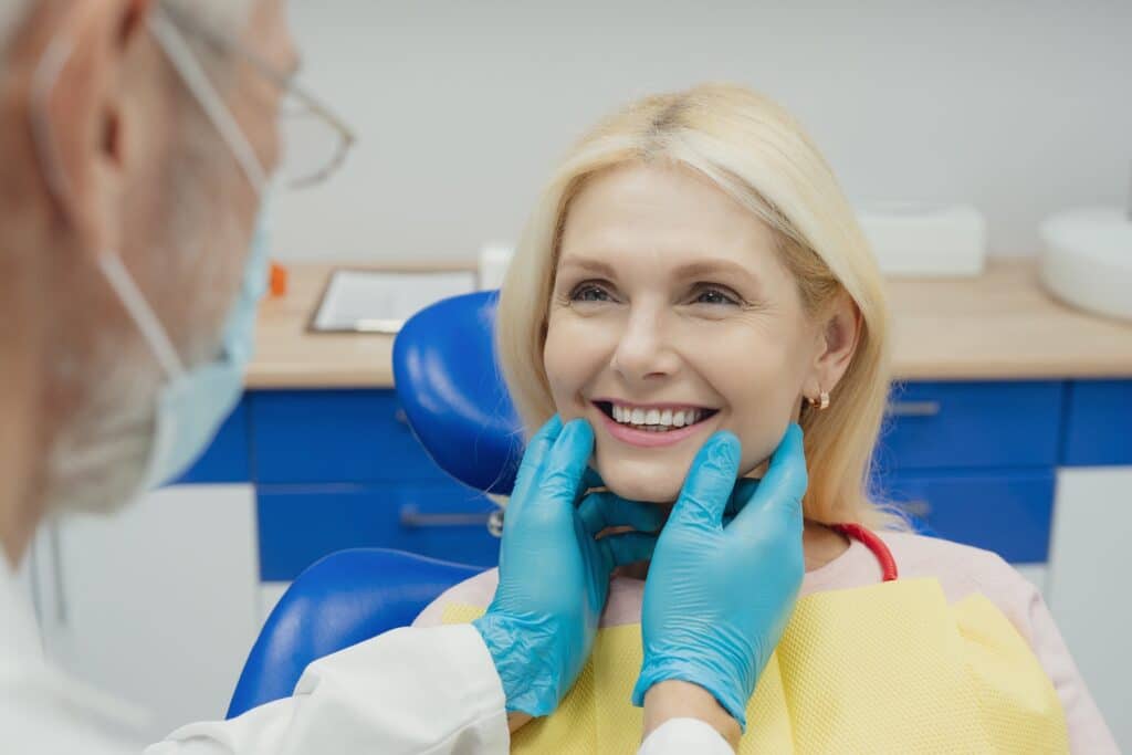 a beautiful women smiling during her dental treatment at dentist in Newport Beach Dental Dental Solutions